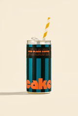 Can of 'Iced Black Coffee' with a straw on a beige background