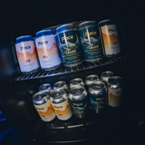 Assorted cans of Pace beer on a dark background