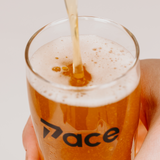 Beer being poured into a glass with 'Pace' branding on a light background